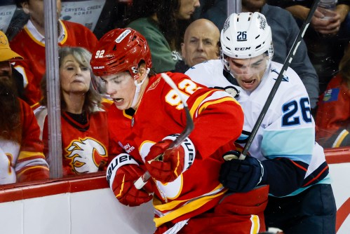 Seattle Kraken's Ryan Winterton, right, checks Calgary Flames' Matvei Gridin during second period NHL hockey action in Calgary on Thursday, Oct. 1, 2026.THE CANADIAN PRESS/Jeff McIntosh
