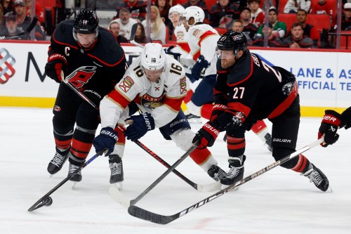 Florida Panthers' Aleksander Barkov (16) battles for the puck between Carolina Hurricanes' Jordan Staal, left, and Nikolaj Ehlers (27) during the third period of an NHL hockey game in Raleigh, N.C., Tuesday, Sept. 29, 2026. (AP Photo/Karl DeBlaker)