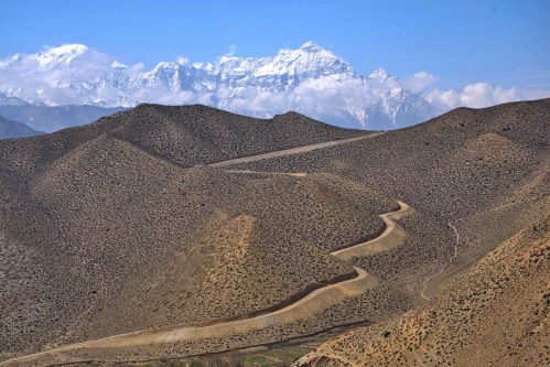 FILE- A dirt road through barren mountains in the Mustang region, 462 kilometers (288 miles) west of Kathmandu, Nepal, Thursday, April 17, 2025. (AP Photo/Niranjan Shrestha, File)