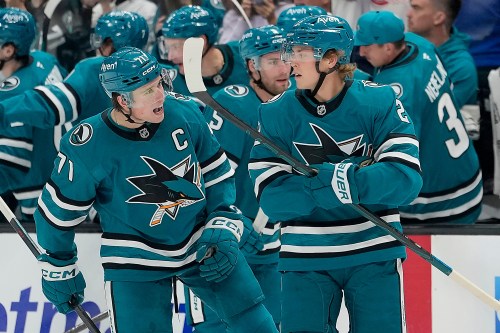 San Jose Sharks center Will Smith (2) celebrates with teammate Macklin Celebrini (71) after scoring a goal against the Florida Panthers during the second period of an NHL hockey game in San Jose, Calif., Thursday, Oct. 1, 2026. (AP Photo/Tony Avelar)