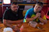 UAW Local 402 members Chaz Graham, left, and Kyle Bos, right, share a beer at Fricker's restaurant and bar in Springfield, Ohio, on Wednesday, Sept. 30, 2026, on old Navistar's last day at its Springfield plant. (AP Photo/Carolyn Kaster)