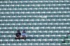 Los Angeles Dodgers fans look on among empty seats as they shield themselves from the sun and heat before Game 1 of a National League Division Series baseball game against the Atlanta Braves Saturday, Oct. 3, 2026, in Los Angeles. (AP Photo/Jae C. Hong)