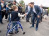 Parti Québécois Leader Paul St-Pierre Plamondon shakes hands with six year old Olivier Boyer as he makes a campaign stop in Montreal on Sunday, Oct. 4, 2026. Quebec votes in a provincial election on Monday. THE CANADIAN PRESS/Christinne Muschi