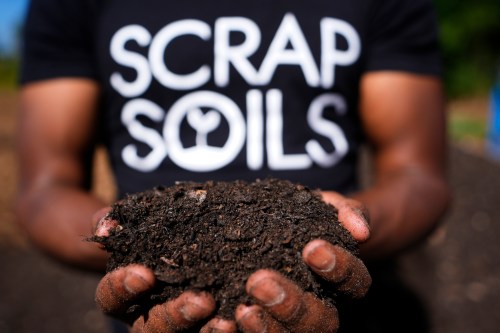 Ricky Blanding, founder of Scrap Soils, holds composted soil at Sanctuary Farms, Monday, Sept. 14, 2026, in Detroit. (AP Photo/Paul Sancya)