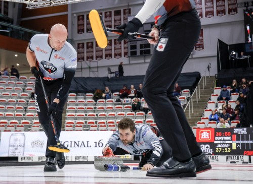 Team Dunstone skip Matt Dunstone, centre, makes a shot as teammates Ryan Harnden, left, and EJ Harnden sweep against Team Jacobs during the men's final at the PointsBet Invitational in Calgary on Oct. 5, 2025. THE CANADIAN PRESS/Jeff McIntosh