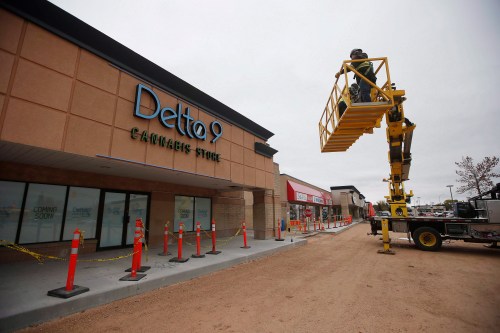 Sign installers Victor Lagasse and Dwight Galbraith work on the finishing touches to the new Delta 9 Cannabis Store signage in Winnipeg, Manitoba Thursday, October 11 2018. Cannabis becomes legal in Canada on October 17. THE CANADIAN PRESS/John Woods