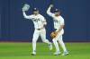 Tampa Bay Rays right fielder Victor Mesa Jr., left, and Rays second baseman Richie Palacios, right, react after Mesa Jr. caught a fly ball hit by New York Yankees' Spencer Jones that hit the ceiling of Tropicana Field for an out during the second inning in Game 2 of an American League Division Series baseball game Monday, Oct. 5, 2026, in St. Petersburg, Fla. (AP Photo/Chris O'Meara)