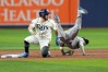 New York Yankees second baseman Jazz Chisholm Jr., right, flips over Tampa Bay Rays' Jonathan Aranda, left, while committing a throwing error allowing Rays' Yandy Díaz to score during the first inning in Game 2 of an American League Division Series baseball game Monday, Oct. 5, 2026, in St. Petersburg, Fla. (AP Photo/Chris O'Meara)