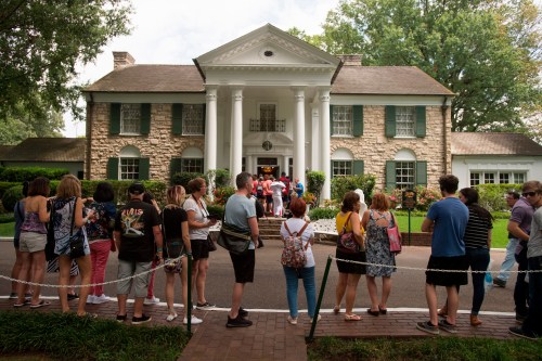 FILE - Fans wait in line outside Graceland, Elvis Presley's Memphis home, Aug. 15, 2017, in Memphis, Tenn. (AP Photo/Brandon Dill, File)