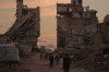 Palestinians walk along a street surrounded by buildings destroyed in Israeli military strikes during the Israel-Hamas war in Gaza City, Tuesday, Oct. 6, 2026. (AP Photo/Jehad Alshrafi)