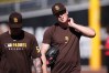 San Diego Padres pitcher Mason Miller, right, walks with pitcher Adrian Morejon during training a day before Game 3 of a National League Division Series baseball game against the Milwaukee Brewers Monday, Oct. 5, 2026, in San Diego. (AP Photo/Gregory Bull)