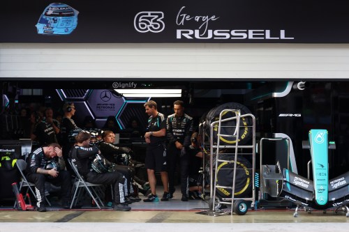 Mercedes crew members for driver George Russell of Britain react inside the garage during the Bahrain Grand Prix in Sepang, Malaysia, Sunday, Oct. 4, 2026. (Annice Lyn/Pool via AP )