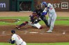 Los Angeles Dodgers center fielder Andy Pages (44) hits a two run RBI-single off a pitch by Atlanta Braves pitcher Didier Fuentes, bottom left, during the seventh inning in Game 4 of baseball's National League Division Series, Wednesday, Oct. 7, 2026, in Atlanta. (AP Photo/Colin Hubbard)