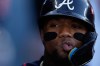 Atlanta Braves' Ronald Acuña Jr. celebrates with teammates after scoring off an RBI single by Mauricio Dubón during the first inning of Game 2 of a National League Division Series baseball game against the Los Angeles Dodgers Sunday, Oct. 4, 2026, in Los Angeles. (AP Photo/Mark J. Terrill)