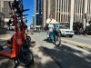 A cyclist and e-scooter user are seen in a Halifax bike lane on Wednesday Oct. 7, 2026. The Nova Scotia government says its new Traffic Safety Act aims to protect vulnerable road users. THE CANADIAN PRESS/Devin Stevens