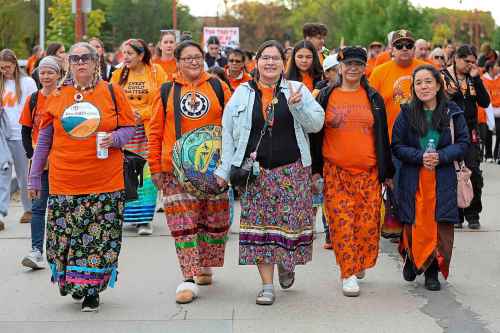 Monica Campeau (second from far left) is pictured walking with her daughter Verna Campeau (middle) and her mother-in-law Kimberly Scott (second from far right). (Brook Jones / Free Press)