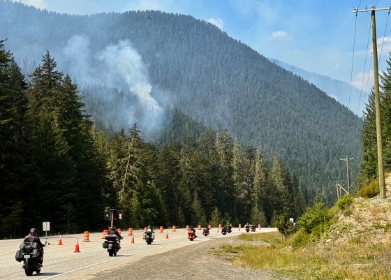 Fire crews drop water on a wildfire along Highway 3 in Manning Park, British Columbia, as fires burn throughout the southeastern part of the province on Aug. 12, 2026. (Haven Daley / The Associated Press files)