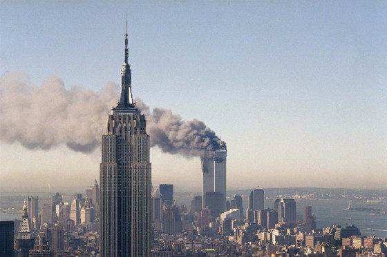 The twin towers of the World Trade Center burn behind the Empire State Building in New York after the terrorist attack on Sept. 11, 2001. (Marty Lederhandler / The Associated Press files)