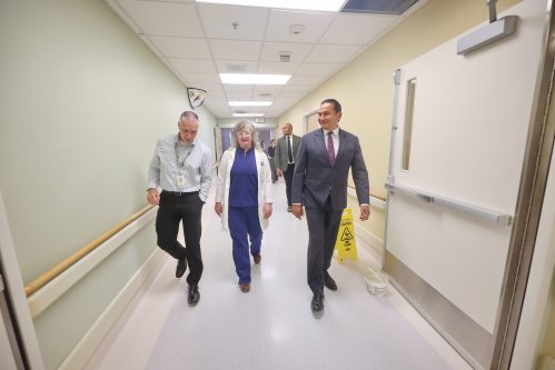 Scott Kirk, director of operations for the Brandon Regional Health Centre, from left, walks with Dr. Arleigh Trainor and Manitoba Premier Wab Kinew down a hallway during a tour of the Brandon Regional Health Centre’s emergency department on Thursday afternoon, after the province’s doctor recruitment announcement for Prairie Mountain Health. (Matt Goerzen/The Brandon Sun)