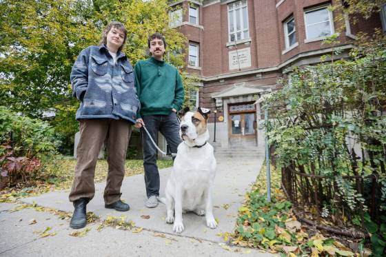 Avery Helm and Quincy Houdayer with dog Honey outside their Furby Street apartment. (John Woods / Free Press)