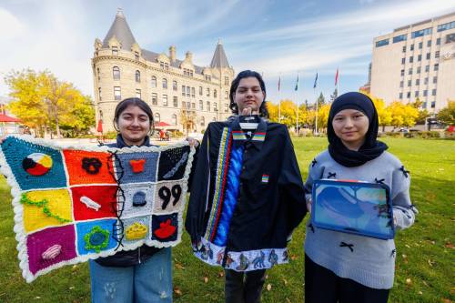 MIKE DEAL / FREE PRESS
                                From left: Students Swasti Kumar, 14, with her crochet project about trauma and abnormal DNA musculation in residential school survivors, Nazareth Mallett with his ribbon shirt, and animator/filmmaker Setayesh Khasheei.