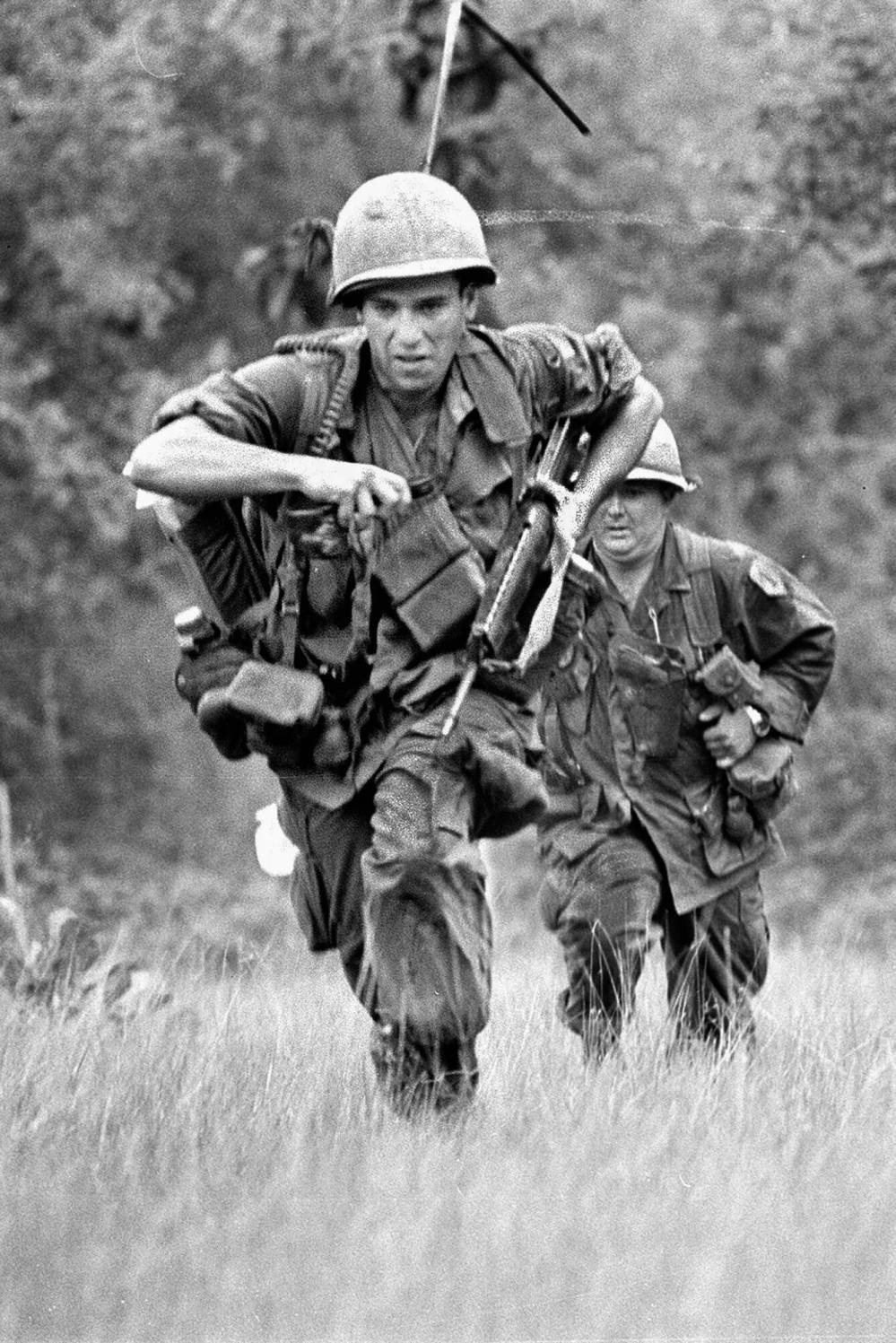 The Associated Press
Two infantrymen sprint across a clearing in War Zone D, where a U.S. battalion was trapped under automatic weapons fire from surrounding Viet Cong troops, 50 miles northeast of Saigon, Vietnam, in this June 18, 1967 photo.