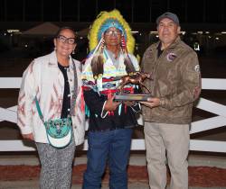 Jason Halstead / Assiniboia Photo
                                Chief Murray Clearsky (centre) presents the championship trophy to 2026 leading Assiniboia Downs trainer Jerry Gourneau, with his wife Lyn Blackburde.