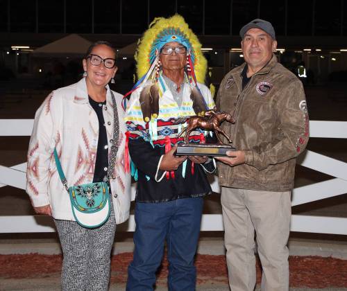 Jason Halstead / Assiniboia Photo
                                Chief Murray Clearsky (centre) presents the championship trophy to 2026 leading Assiniboia Downs trainer Jerry Gourneau, with his wife Lyn Blackburde.
