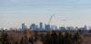 MIKE DEAL / WINNIPEG FREE PRESS An Air Canada plane heads in for a landing about to fly past a crane which is set up at 215 Sinawik Bay where construction of a new building that will open in 2024 as part of the St. James Kiwanis Village, a seniors housing project, with the Winnipeg skyline in the distance Wednesday morning. 231129 - Wednesday, November 29, 2023.