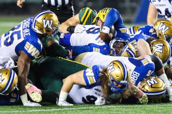CODIE MCLACHLAN / THE CANADIAN PRESS
                                Winnipeg Blue Bombers quarterback Bryce Perkins (9) manages a first down against the Edmonton Elks during first half CFL football action in Edmonton on Friday, Oct. 16, 2026. THE CANADIAN PRESS/Codie McLachlan