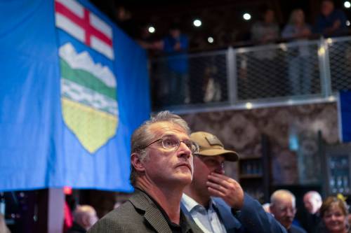 John Ulan / THE CANADIAN PRESS
                                Alberta Prosperity Project supporters watch referendum results in Edmonton on Monday, Oct. 19.