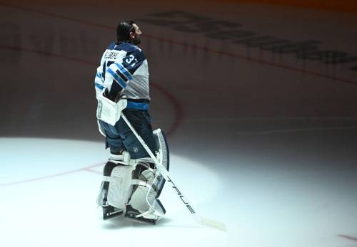 (Philip G. Pavely / The Associated Press files)
                                Hellebuyck takes in the national anthem before the Jets play the Pittsburgh Penguins in March.