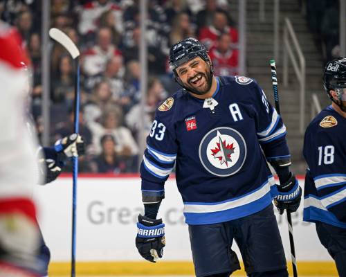 MIKE SUDOMA / FREE PRESS
Winnipeg Jets alumni and crowd favourite Dustin Byfuglien smiles as he’s cheered on during the first period of Saturday night's alumni game at Canada Life Centre.