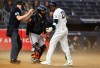 Home plate umpire Nic Lentz, left, calls time after the wind blew up dust during an at-bat of New York Yankees' Jazz Chisholm Jr., right, during the seventh inning of the second baseball game of a doubleheader against the Baltimore Orioles, Friday, Sept. 25, 2026, in New York. (AP Photo/Noah K. Murray)