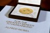 FILE - A Nobel diploma and medal are displayed, Dec. 8, 2020, during a ceremony in New York. (Angela Weiss/Pool Photo via AP, File)