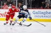 Winnipeg Jets center Cole Perfetti (91) is pursued by Detroit Red Wings center Emmitt Finnie (58) during the third period of an NHL hockey game Sunday, Oct. 4, 2026, in Detroit. (AP Photo/Duane Burleson)