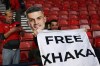 A fan on the stands holds a banner and a picture of Switzerland's player Granit Xhaka before the Nations League soccer match between Scotland and Switzerland in Glasgow, Scotland, Tuesday, Sept. 29, 2026. (AP Photo/Scott Heppell)