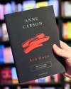 After the announcement of the Canadian writer Anne Carson as the winner of the 2026 Nobel Prize in Literature, a man's hand holds her book 