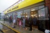 FILE - Luke Churchill, left, stands with his wife Mary and their children, Katie, Liam and Raighan, as they wait in the rain outside an open Waffle House restaurant in Wilmington, N.C., after Hurricane Florence traveled through the area on Sept. 16, 2018. (AP Photo/Chuck Burton, File)