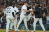 Chicago White Sox relief pitcher Erick Fedde, middle, hands the game ball to manager Will Venable, right, for a pitching change during the fifth inning of Game 4 of baseball's American League Division Series against the Cleveland Guardians, Thursday, Oct. 8, 2026, in Chicago. (AP Photo/Melissa Tamez)