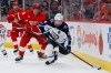 Winnipeg Jets defenceman Josh Morrissey (44) is pursued by Detroit Red Wings centre Andrew Copp (18) behind the net during the third period of an NHL hockey game on Sunday, Oct. 4, 2026, in Detroit. (AP Photo/Duane Burleson)