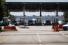 A Canada Border Services Agency officer is silhouetted as motorists wait to enter Canada at the Douglas-Peace Arch border crossing, in Surrey, B.C., on Monday, August 9, 2021. THE CANADIAN PRESS/Darryl Dyck