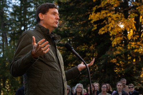 Candidates and supporters look on as NDP Leader David Eby makes an announcement during a campaign stop at Puntledge Park in Courtenay, B.C., Saturday, Oct. 10, 2026. THE CANADIAN PRESS/Chad Hipolito