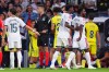 Real Madrid's Vinicius Junior, right, leaves the pitch after being shown a red card during the La Liga soccer match between Real Madrid and Villarreal in Madrid, Spain, Saturday, Oct. 10, 2026. (AP Photo/Manu Fernandez)