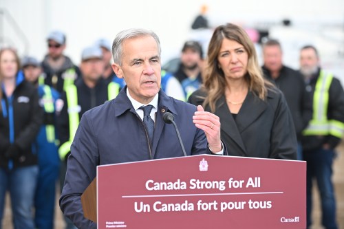 Prime Minister Mark Carney speaks as Alberta Premier Danielle Smith listens in Fort McMurray on Thursday Oct 1, 2026. Prime Minister Mark Carney declared the Pacific Link pipeline project to be in the national interest. THE CANADIAN PRESS/Greg Halinda
