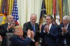 President Donald Trump shakes hands with Sen. Dan Sullivan, R-Alaska, as he speaks in the Oval Office of the White House, Wednesday, Sept. 30, 2026, in Washington, as Commerce Secretary Howard Lutnick, Interior Secretary Doug Burgum and Energy Secretary Chris Wright applaud. (AP Photo/Alex Brandon)