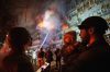 Victoria Deineko, her husband Ievhen Deineko and their daughter Mia look at a multi-story residential building damaged in a Russian missile strike in Kyiv, Ukraine, Tuesday, Oct. 13, 2026. (AP Photo/Evgeniy Maloletka)