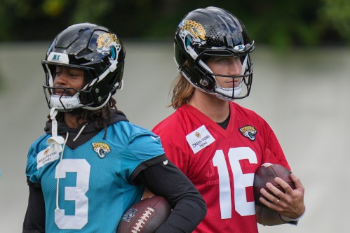 Jacksonville Jaguars' quarterback Trevor Lawrence (16), right, and wide receiver Jakobi Meyers (3) work out during an NFL football practice in Hertfordshire, England, Wednesday, Oct. 14, 2026. (AP Photo/Kin Cheung)