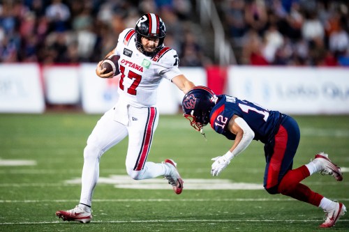 Ottawa Redblacks quaterback Bryson Barnes (17) protects the ball from Montreal Alouettes' Najee Murray (12) during second half CFL football action in Montreal, on Thursday, August 20, 2026. THE CANADIAN PRESS/Christopher Katsarov