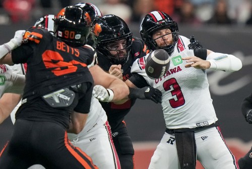 B.C. Lions' Casey Sayles, back left, strips the ball from the hands of Ottawa Redblacks quarterback McLeod Bethel-Thompson (3) forcing a turnover during the second half of a CFL football game, in Vancouver, on Friday, Oct. 9, 2026. THE CANADIAN PRESS/Darryl Dyck